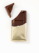 Chocolate bar in gold paper, opened