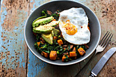 Fried egg with avocado and kale butternut squash hash