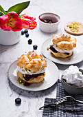 Cream puffs with soy whipped cream, blueberry compote and pistachios