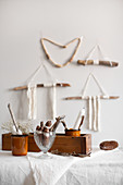 Natural, Bohemian-style arrangement of sticks, wool, fir cones and candles