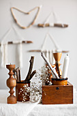 Natural, Bohemian-style arrangement of sticks, wool, candles and candle holders