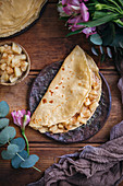 Crêpe filled with sauteed cinnamon and maple syrup apples