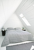 Rustic bedroom under wood-clad gable roof