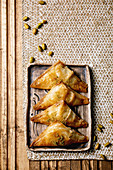 Homemade Turkish traditional dessert baklava with pistachio served on ceramic plate