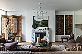 Exotischer Stilmix im Wohnzimmer mit offenem Kamin aus Marmor