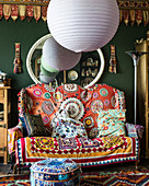 Spherical lampshades and colourful, exotic accessories in living room