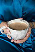 Hands holding a mug of hot chocolate