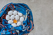 White eggs wrapped in a blue scarf