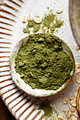 Loose matcha powder into a small bowl on a plate