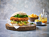 A chicken burger and fries against a light background