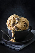 Coffee ice cream with roasted chocolate almonds in a cup.