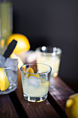 Limoncello with ice cubes and fresh lemon peel