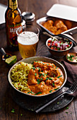 Chicken tikka masala with rice, salad and beer
