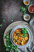 Bowl of delicious vegan chickpea curry with herbs