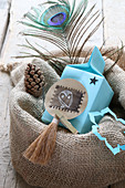 Pale blue gift bag with tag in jute sack