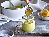 Vegan Sauce Hollandaise being filled into a jar