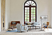 Large arched window in living room with high ceiling