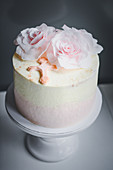 A white chocolate cake with edible paper roses