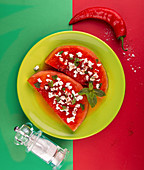 Grilled watermelon with feta cheese, chili pepper and mint