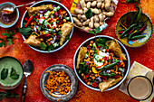 Chaat salad (spicy chickpea salad, India) with samosas and peanuts