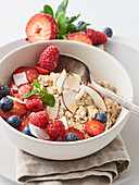 Porridge with fresh berries and coconut flakes