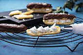 Chocolate eclairs being filled with whipped soya cream