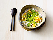 A green smoothie bowl with spinach, avocado, mango and coconut