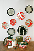 Decorative wall plates in black and coral red above biscuits in biscuit tins