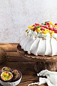 Pavlova, served with whipped cream and fresh fruit