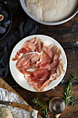 Plate of prosciutto, figs and rosemary