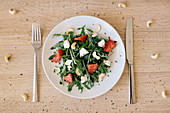 Rocket salad with feta cheese, cashew nuts and tomatoes