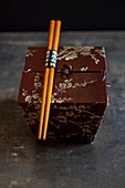 An oriental silk box with chopsticks