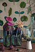 Carnation, chrysanthemum, ranunculus and artichokes in glass vase