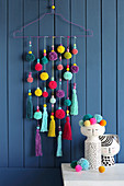 Handmade wall-hanging of pompoms and tassels