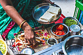 A woman preparing street food, India