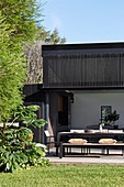 Table and bench on the terrace in front of the modern architect's house