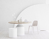 Artistic still life in white on a round table in front of a fan
