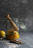 Lemons in a jar with pestle