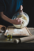 Kneading Italian pizza dough on the wood table