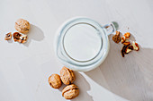 Jar of milk and nuts on table