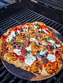 A grilled seafood pizza