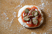 A mini pizza topped with capers and anchovies