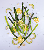 Blanshed green asparagus, lemon and avocado slices, mint leaves and herbs