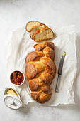 Sweet bread sliced with a pot of marmalade and butter