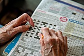 Care home resident doing a crossword puzzle