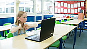 School girl using laptop