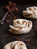 Dough shaped into cinnamon buns, ready to bake