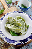 Spinach ravioli (pierogi, cooked dumplings)
