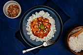 Mango curry with tofu topped with crushed toasted cashews and cilantro on jasmine rice