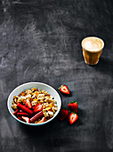 Breakfast setting with granola and strawberries